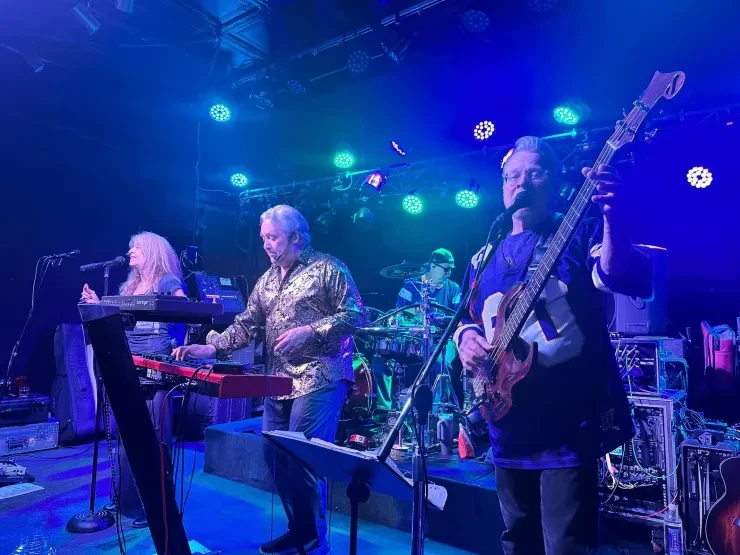 Baibi, Loren, and Rick performing together – blue and green stage lighting