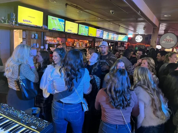 Packed bar crowd at a Flying Train Wreck show – Coors Light signage visible