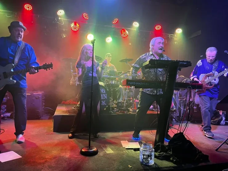 Flying Train Wreck full band on stage – red and green overhead lights